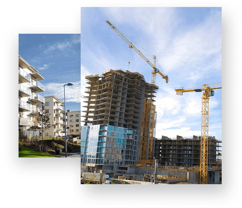 A building under construction with cranes in the background.