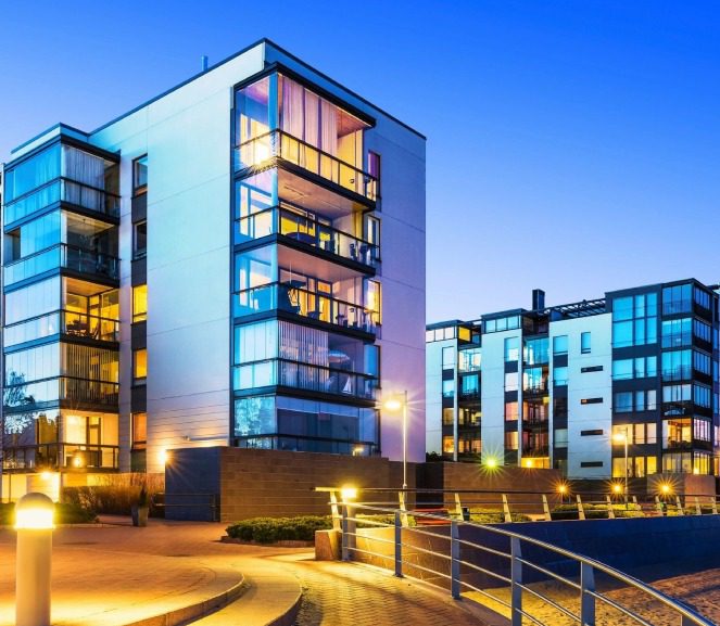 A group of buildings that are lit up at night.