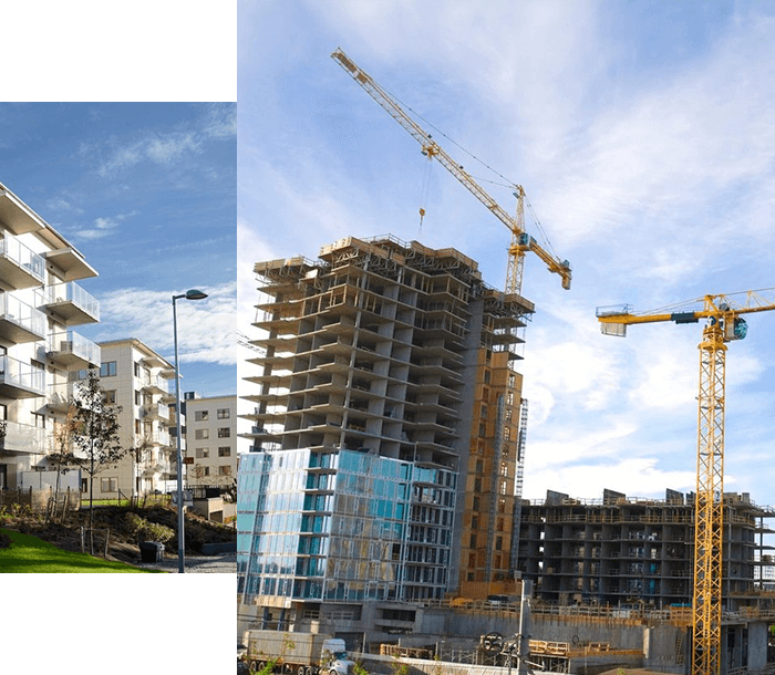 A building under construction with cranes in the background.